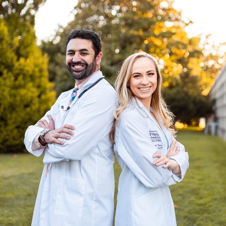 VIrtual Physio team photo- Cameron and Lindsay standing back to back with arms crossed