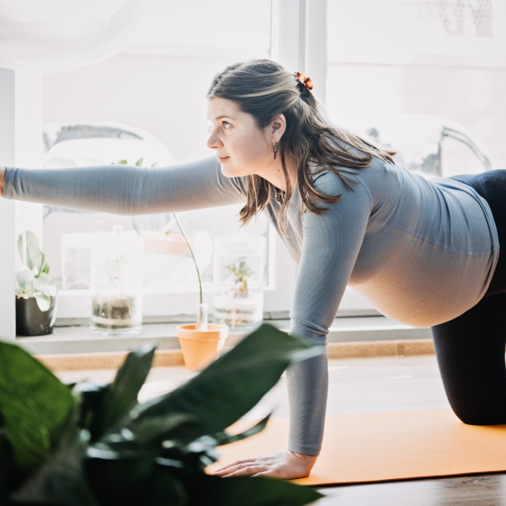 pregnant woman on yoga matt